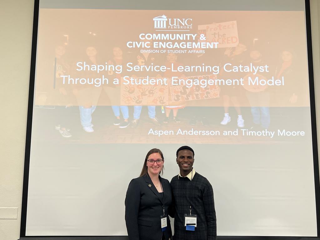 Aspen Andersson, left, and Timothy Moore deliver their presentation at the 2023 IMPACT Conference h