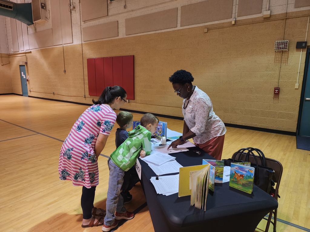 Pamela Eseigbe engages with a parent at the Parent Reading Workshop on April 20, 2023