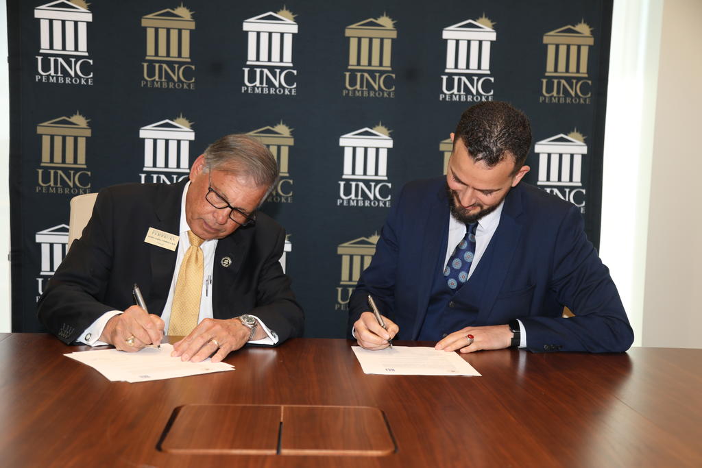 UNCP Chancellor Robin Gary Cummings (left) and Dr. Oussama Ammar, dean of programs at Montpellier Business School, establish a partnership during a MOU signing event at UNC Pembroke.