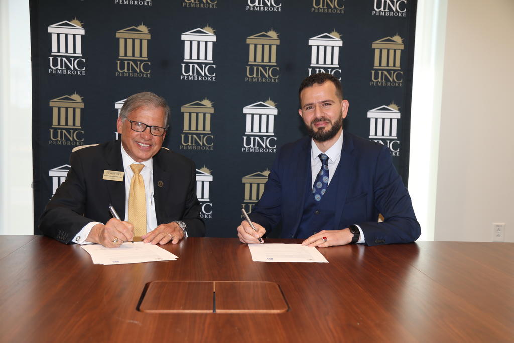 UNCP Chancellor Robin Gary Cummings (left) and Dr. Oussama Ammar, dean of programs at Montpellier Business School, establish an academic partnership during a MOU signing event at UNC Pembroke.