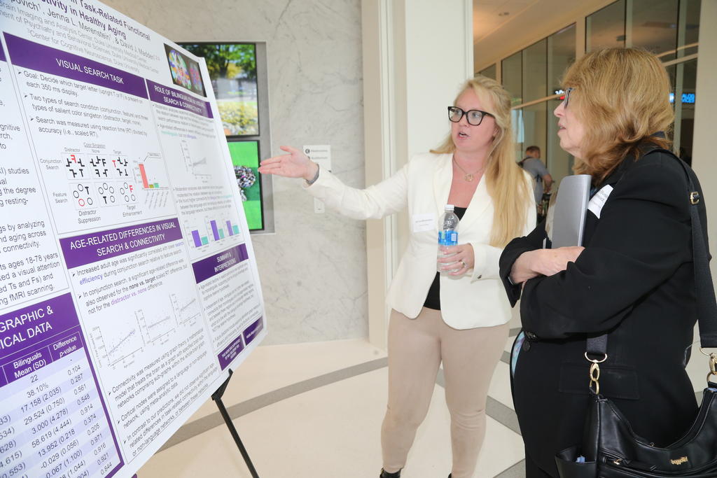 Dr. Jan Busby-Whitehead, co-lead of the Research and Education Component of the Duke-UNC Alzheimer’s Disease Research Center, engages with a presenter at the 2023 SLAM-DUNC conference