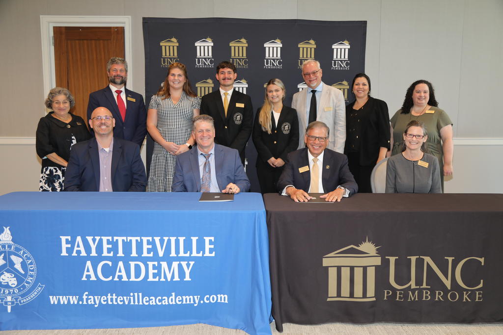 Representatives from Fayetteville Academy join administrators, faculty and students at UNCP during the MOU signing event at UNC Pembroke on July 25, 2023