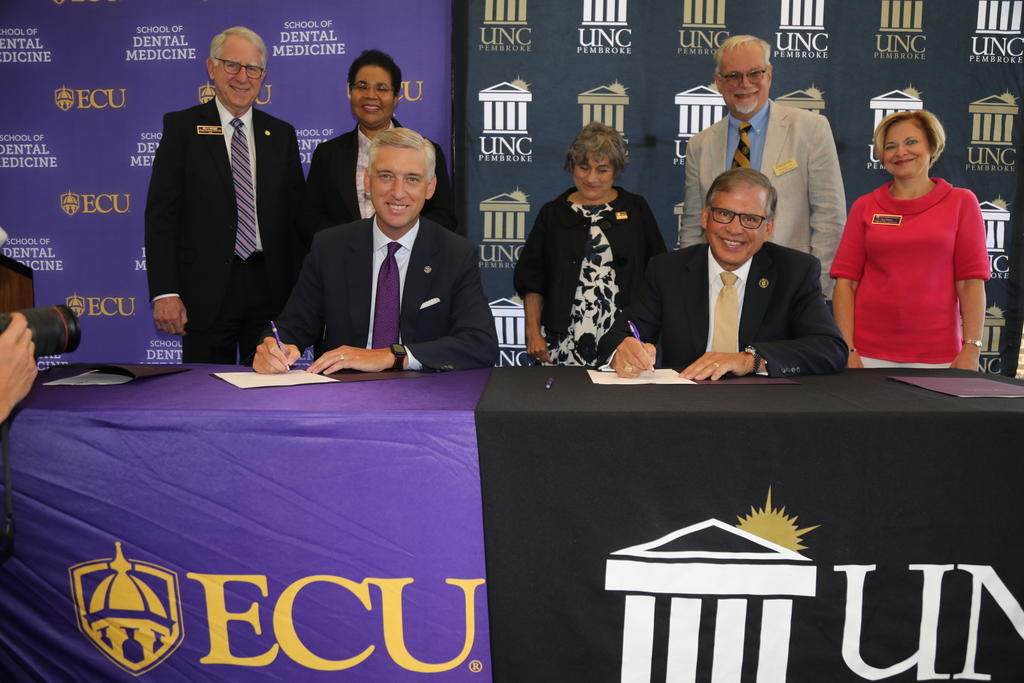 ECU Chancellor Phillip Rogers (seated left) and UNCP Chancellor Robin Gary Cummings signed an Early Assurance Agreement (EAA) between UNCP and ECU School of Dental Medicine