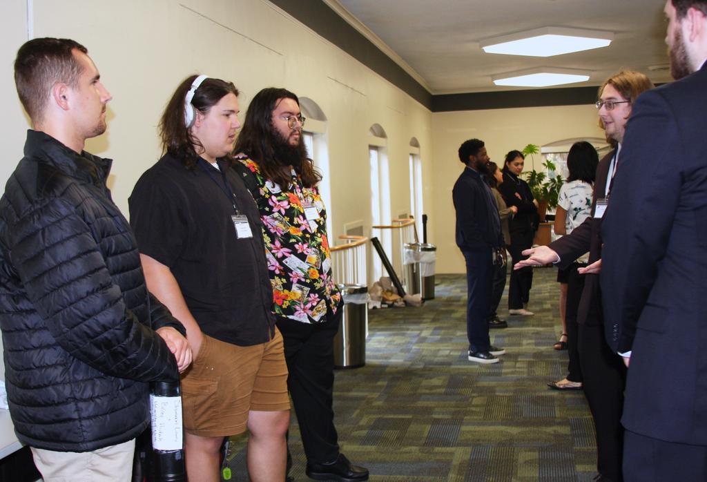UNCP students (left) learn about research on other campuses