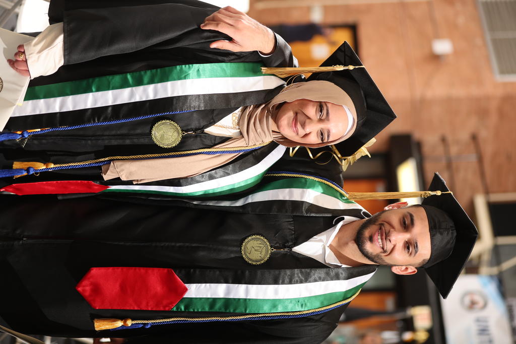 Asil Abudayeh and her younger brother, Ayed Abudayya, share a moment at Winter Commencement on December 9, 2023
