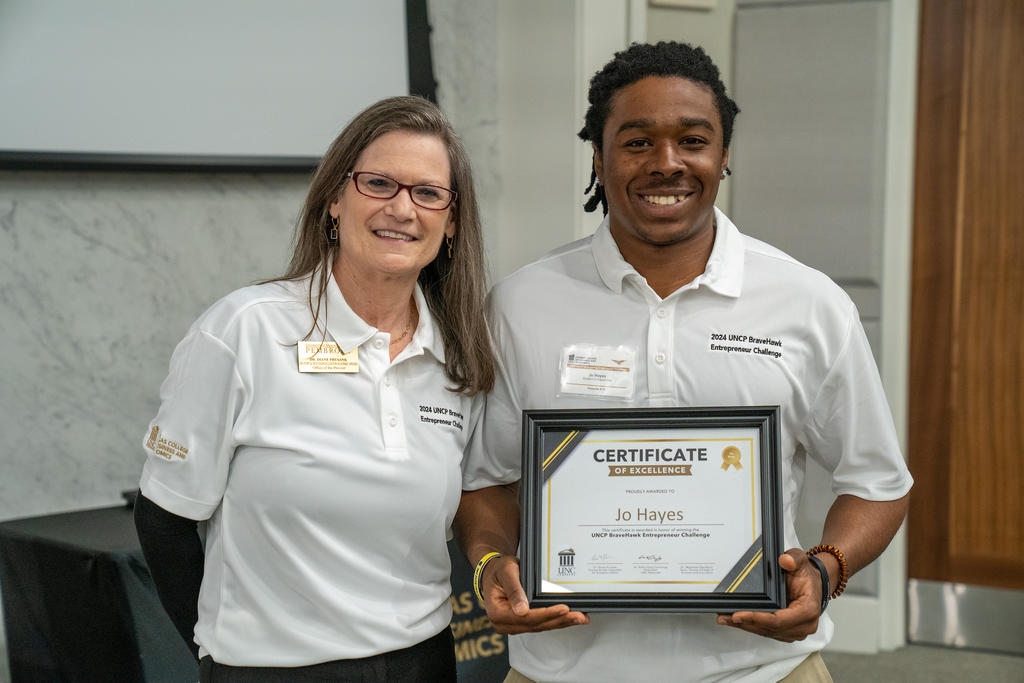 Jo Hayes (right) took home first place in UNCP’s first BraveHawk Entrepreneur Challenge. Pictured with Hayes is Dr. Diane Prusank, provost and vice chancellor for Academic Affairs