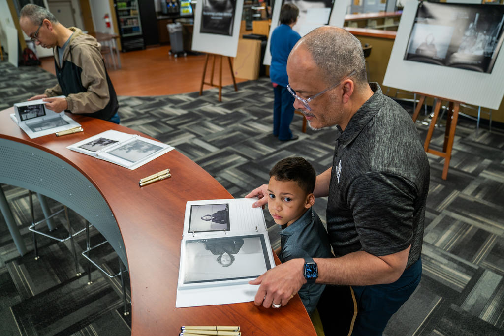 Dr. Lawrence Locklear examines photos taken of Robeson County families in 1938-1939