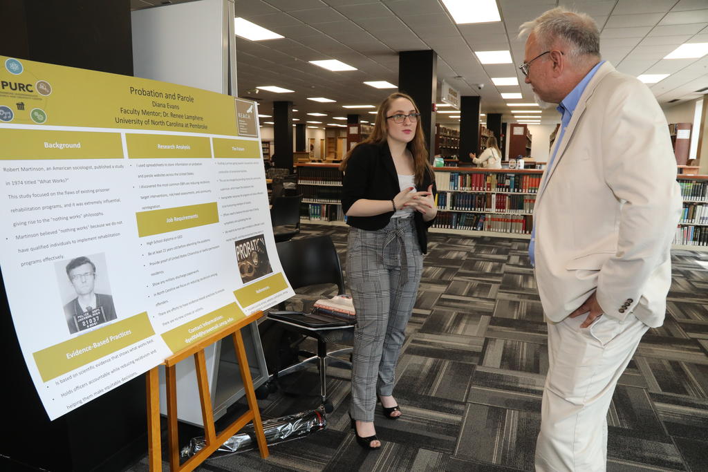 REACH Fellow Diana Evans discusses her research with Dr. Richard Gay, dean of the College of Arts and Sciences