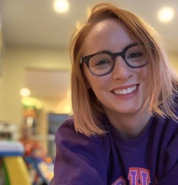 Girl with glasses smiling at camera