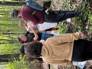 Service-learning class in the woods collecting insects 