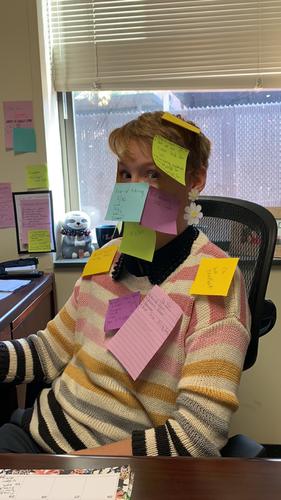 Woman with short hair covered in post it notes