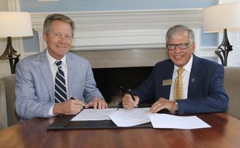 UNC-Chapel Hill Chancellor Kevin M. Guskiewicz (left) signs the MOU agreement with UNCP Chancellor Robin Gary Cummings